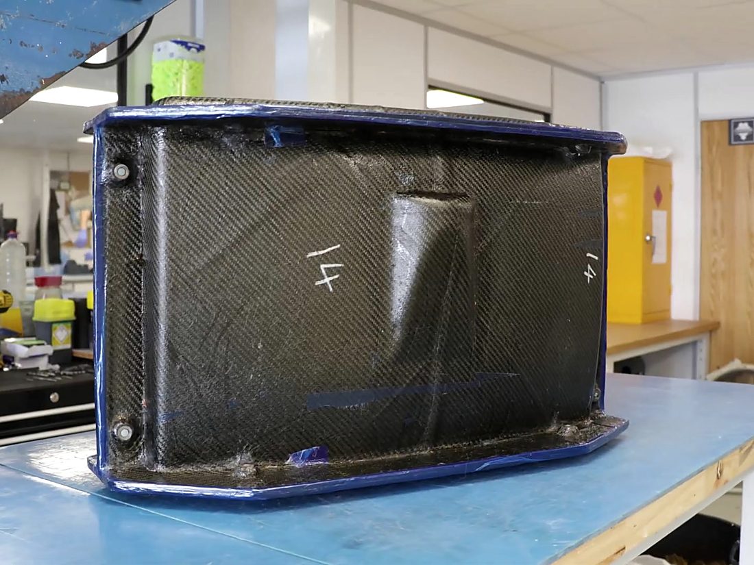 Finished carbon fibre enclosure